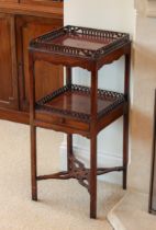 A George III mahogany two tier night table or etagere - the two square tiers with lancet pierced