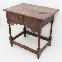 An early 18th century joined oak single-drawer side table - the boarded, moulded top over a single