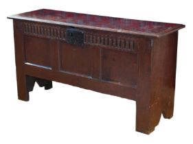 A late 17th century boarded oak chest - the moulded, single plank top with later hinges, over