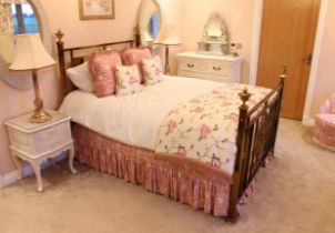 An antiqued brass double bed in the 19th century style - the head and foot boards with central