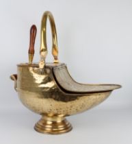 A large early 20th century brass coal scuttle - embossed in the Art Nouveau manner, swing-handle and