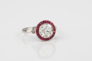 A fine Art Deco platinum, ruby and diamond target ring - the 1.72ct old brilliant cut diamond within