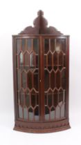 A Georgian-style mahogany glazed hanging corner cabinet - early 20th century, the moulded cornice