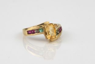 A 10ct gold multi-gem set ring - stamped '10K', the central oval cut citrine over a twist-setting