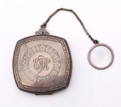 A sterling silver decorative compact and chain