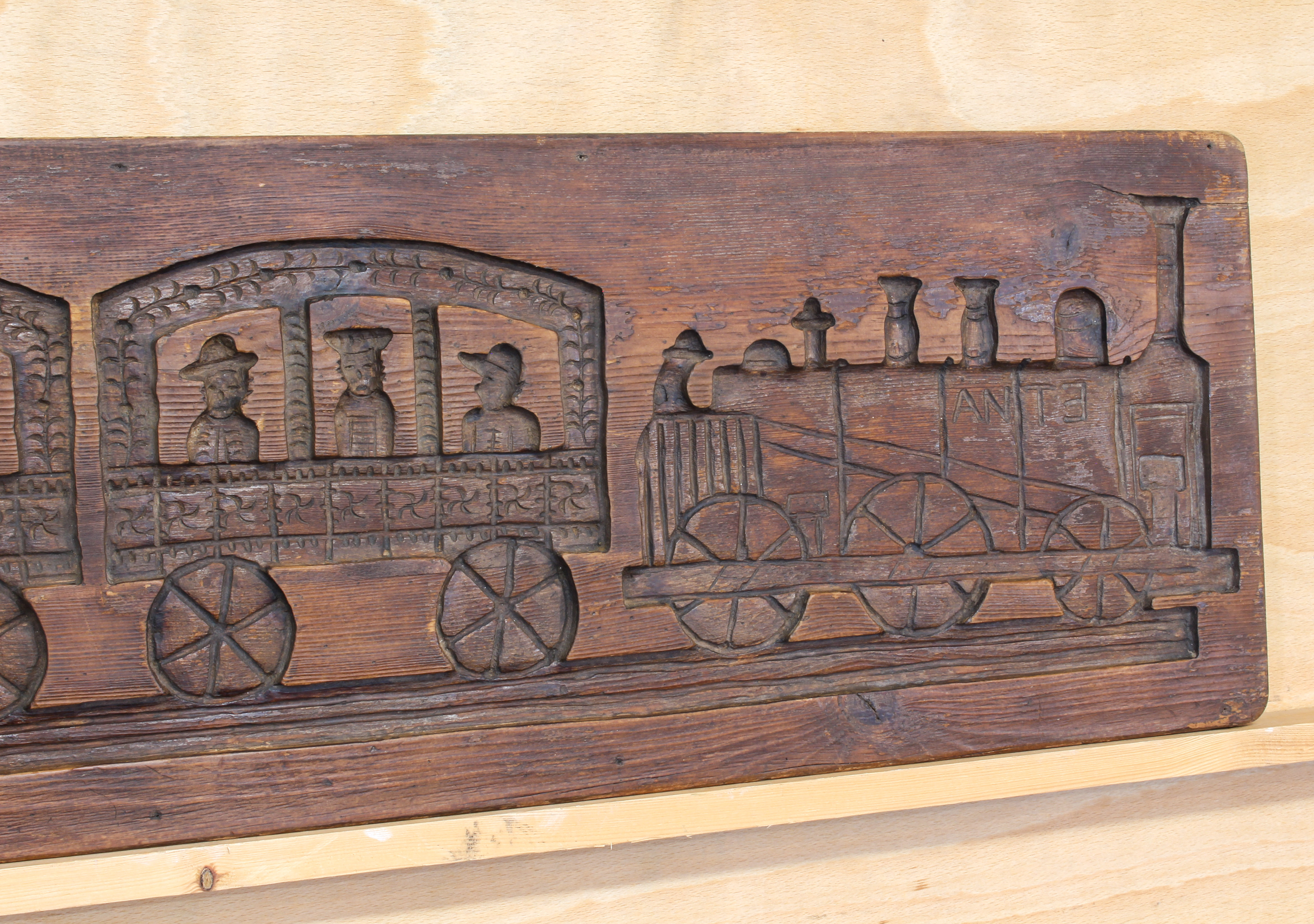A vintage stained pine panel or mould carved in counter-relief with a steam train - 'Etna', with two - Image 2 of 4