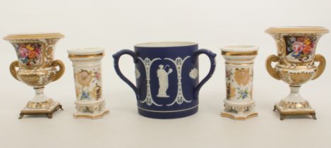 A pair of Derby style porcelain two-handled urns - late 20th century, painted with floral reserves