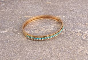 An Edwardian 18ct gold, turquoise and seed pearl hinged bangle - unmarked, tests as 18ct gold, the