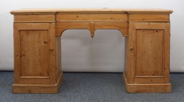 A mid-19th century waxed pine inverted breakfront pedestal sideboard - the ogee moulded top with