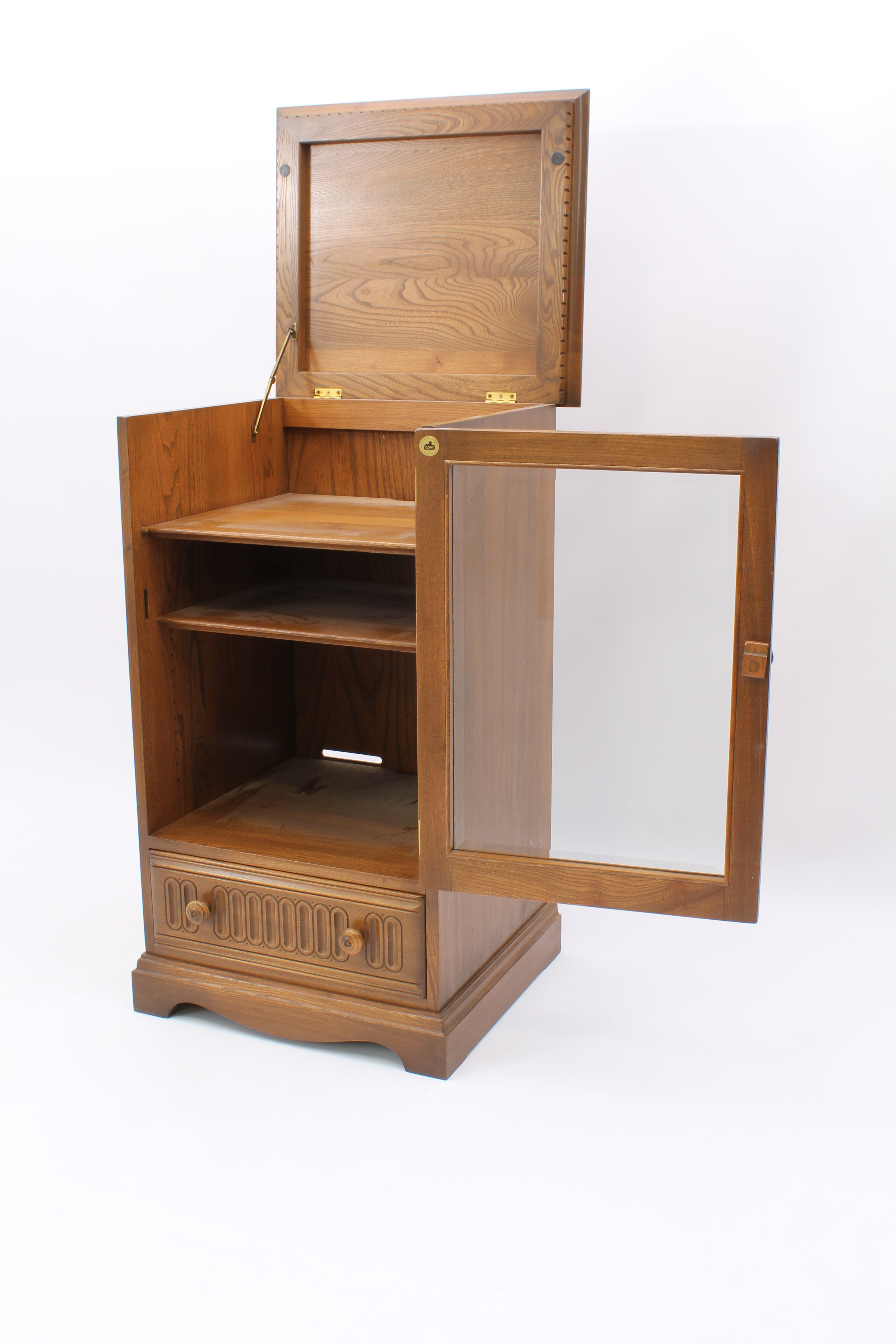 An Ercol elm hi-fi cabinet - with dentil frieze over a glazed door enclosing two shelves, above a - Image 5 of 13