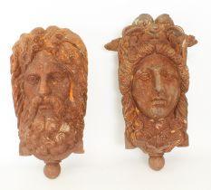 A pair of Victorian cast iron masks from the Madeira Terrace in Brighton, Sussex - one depicting