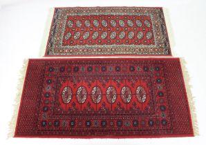 A Turkoman style rug - together with a similar machine-made rug, 174 x 90 cm and 149 x 81 cm. (2)