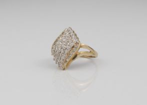 A 9ct gold and diamond cluster ring - London hallmarked, the twist, foliate shaped setting with