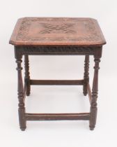 An early 18th century carved oak centre table - the rectangular top with clipped corners, carved