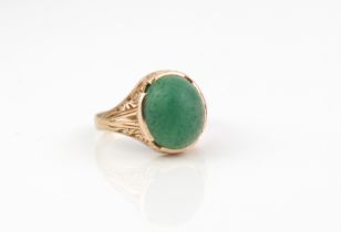 A 9ct gold cabochon set ring - probably agate, the slightly mottled green stone in a carved and