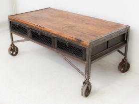 A industrial hardwood and wrought-iron coffee table: the hardwood top on a wrought-iron frame with