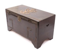 An early 20th century stained camphor wood trunk - the lid relief carved with the regimental crest