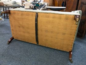 A Victorian walnut and upholstered two-seater sofa by Howard & Sons of London - with low scroll back