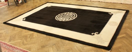 A black ground Chinese wool rug, 273 x 185 cm.