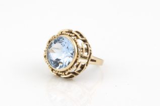 A 9ct gold ring set with a large blue stone - with British import hallmarks, the 13.5mm round cut