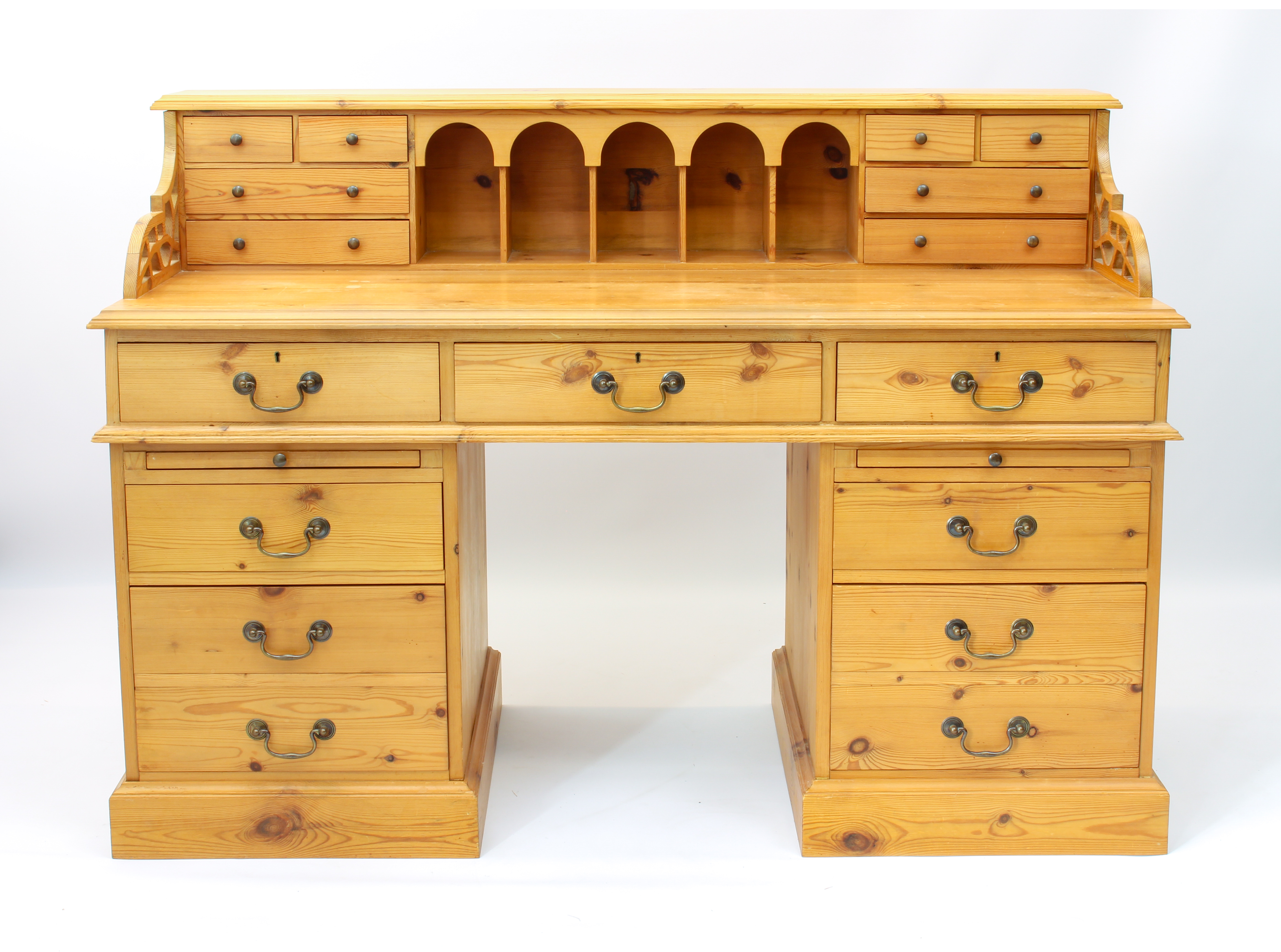 A large pine double pedestal desk - the raised gallery back with five arched pigeonholes flanked