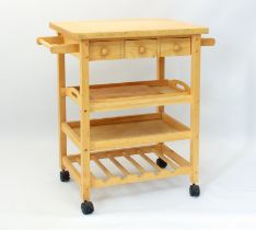 A modern beech butcher's block style kitchen trolley - the rectangular top over three frieze drawers