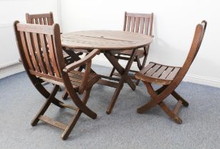 A hardwood garden table and four chairs - by Bridgman of Enfield, the circular table and chairs