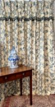 A pair of handmade curtains in medium-weight printed cotton fabric, pale yellow and cream floral