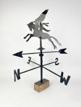 A wrought iron weather vane - black painted, the arrow pointer surmounted by a Perseus riding the