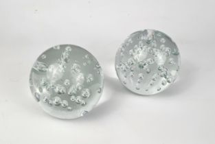 A pair of dump-style bubble glass spherical doorstops