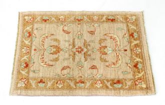 A small Pakistan wool rug - retailed by G. H. Frith Ltd., with a central lozenge medallion and