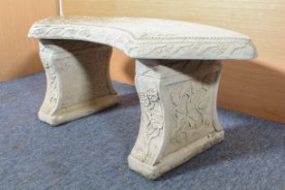 A composite stone curved garden seat - three-part, decorated with ivy leaves and trailing flowers,