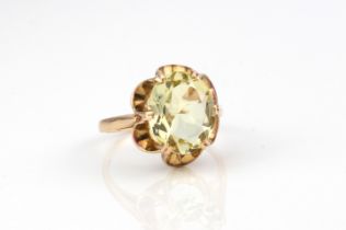 A 9ct gold and citrine single stone ring - the pale lemon yellow oval cut citrine, approx. 12 x 9.