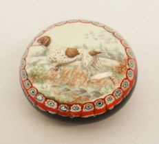 A glass paperweight decorated with a scene of a pointer within a millefiori border