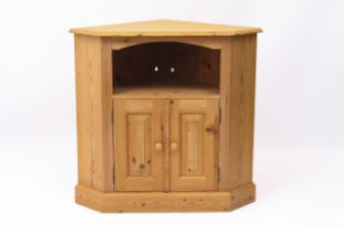 A pine corner cabinet - with an open shelf over a pair of panelled doors enclosing a cupboard with