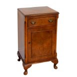 A walnut bedside cabinet in Georgian style - reproduction, the moulded, cross-banded top over a