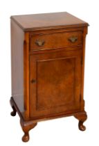 A walnut bedside cabinet in Georgian style - reproduction, the moulded, cross-banded top over a