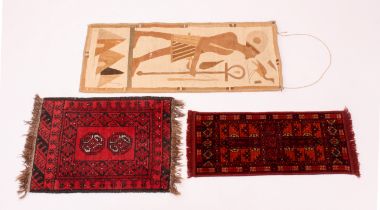 Two tribal style small rugs - together with a 1920s Egyptian Revival wall hanging, 78 x 33 cm, 67