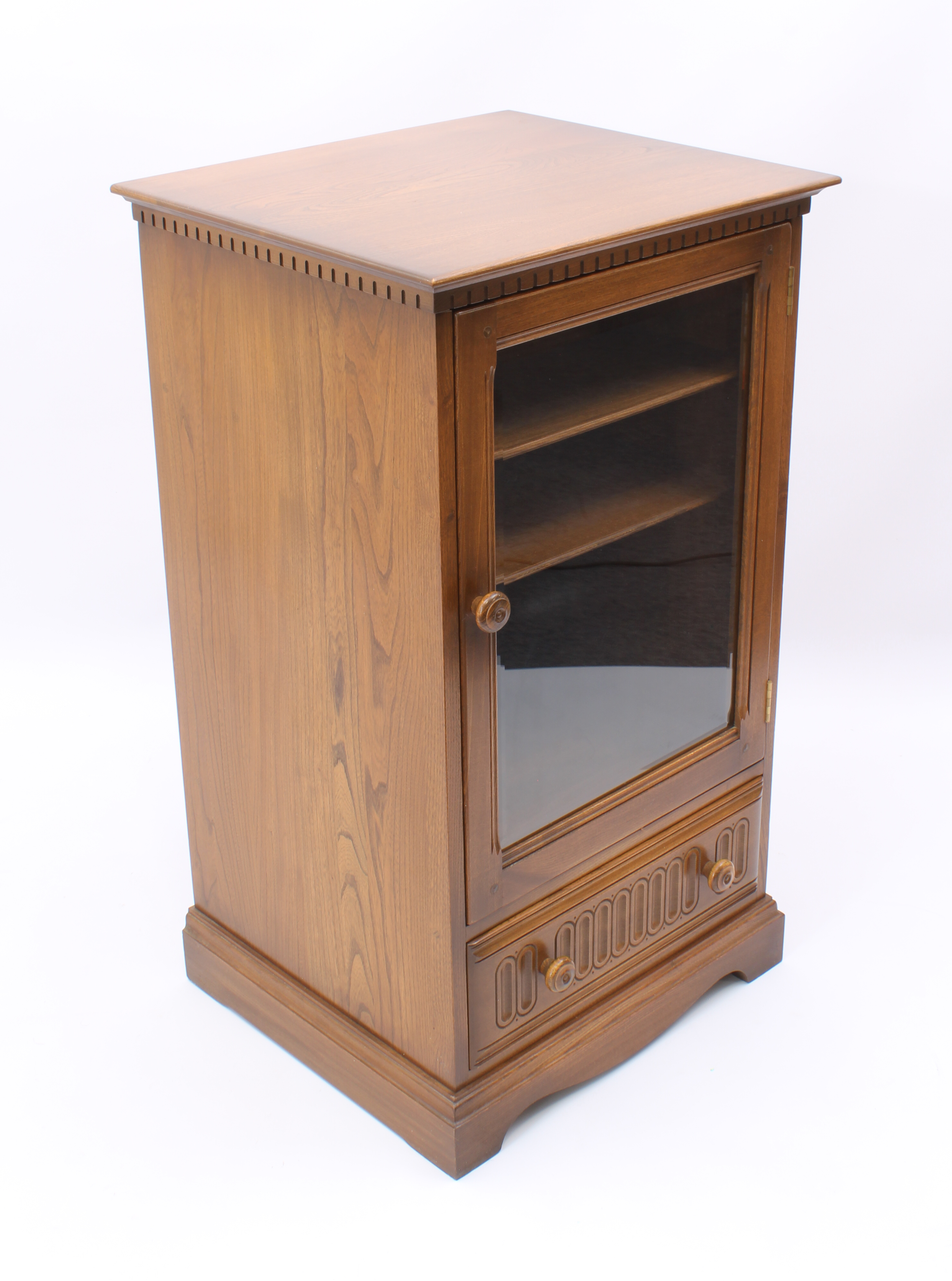 An Ercol elm hi-fi cabinet - with dentil frieze over a glazed door enclosing two shelves, above a - Image 2 of 13
