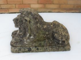 A composite stone figure of a recumbent lion - 69 cm long, 50 cm high.