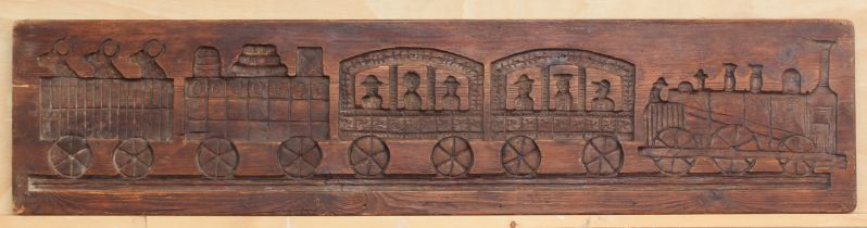 A vintage stained pine panel or mould carved in counter-relief with a steam train - 'Etna', with two