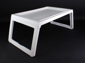 A set of ten white plastic folding lap tray-tables - nine in their original cardboard packaging, one