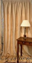 A pair of pale caramel-coloured, cotton velvet curtains with gold and pale lavender damask border to