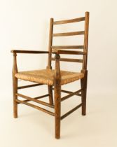 An Edwardian beech wood child's ladderback chair - with rush seat, 37 cm wide, 63.5 cm high.