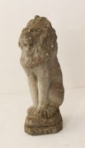 A composite stone figure of a seated lion - 56 cm high.