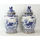 A pair of large Chinese blue and white covered baluster vases - late 20th century with apocryphal