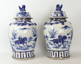 A pair of large Chinese blue and white covered baluster vases - late 20th century with apocryphal