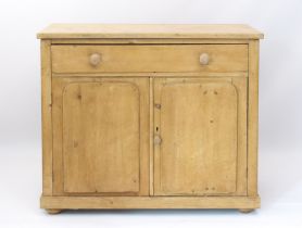 A Victorian stripped pine buffet or side cabinet - with one long drawer over a pair of cupboard