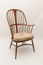 An Ercol beech and elm Windsor elbow chair - with original gold maker's label to underside, with