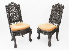 A matched pair of Chinese carved hardwood side chairs, 19th century - the backs carved and pierced